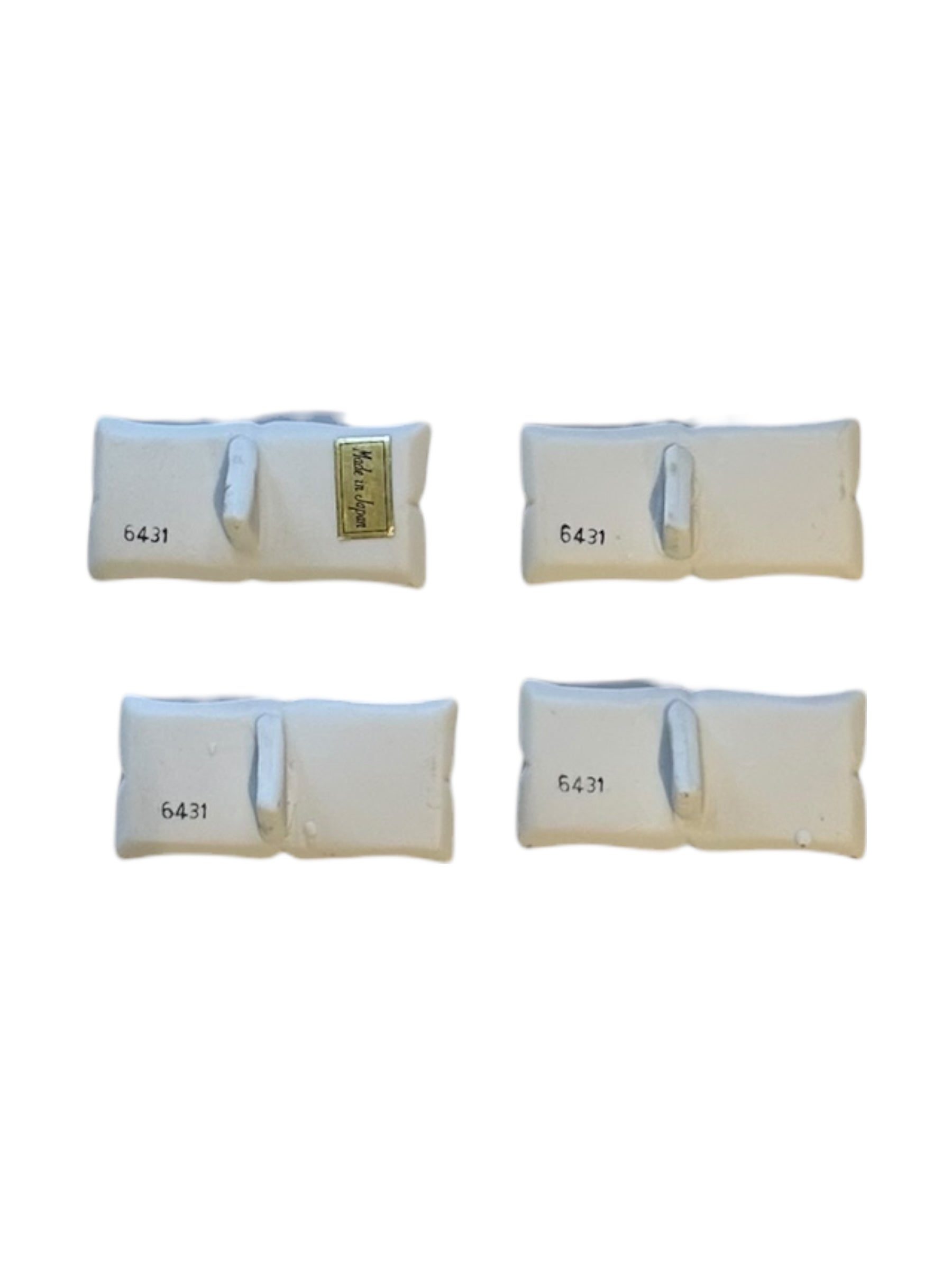 Underside of the floral place card holders showing the 6431 mark and Made in Japan label