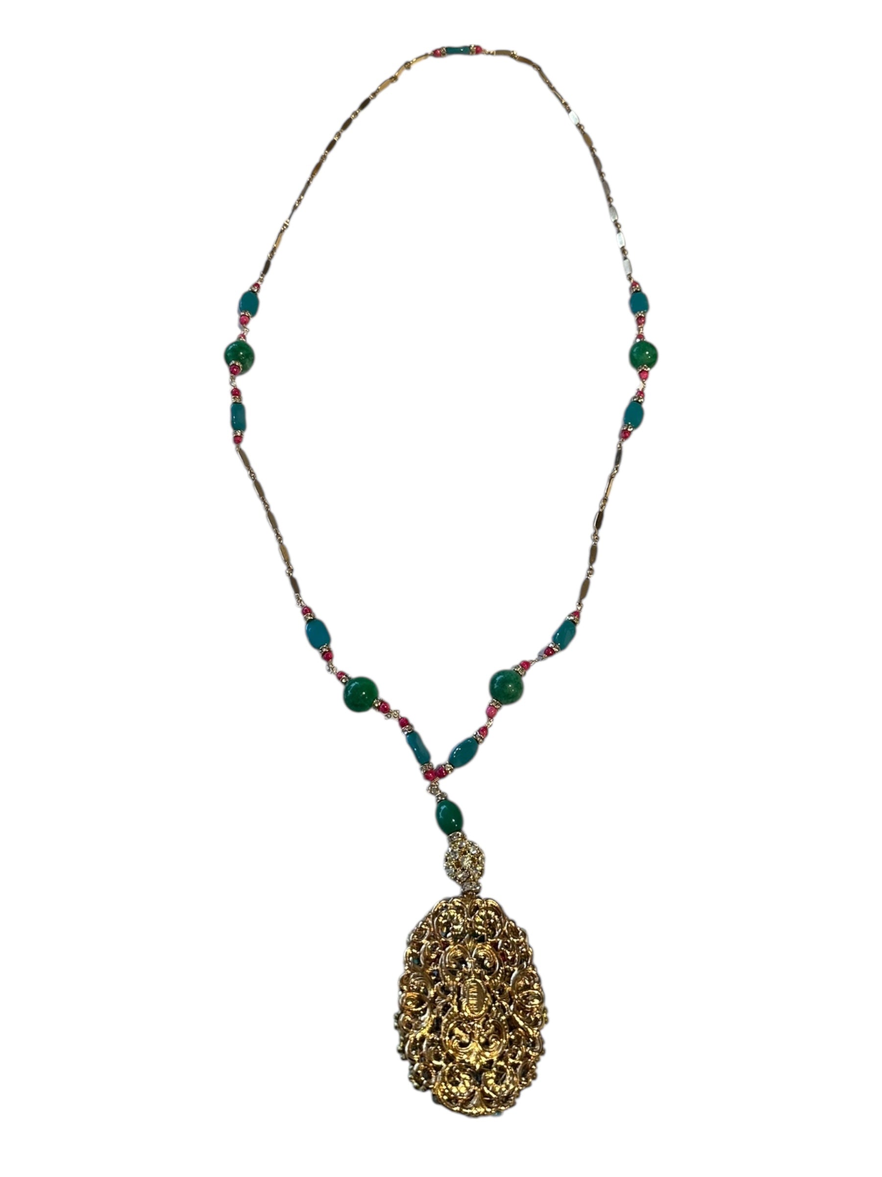 Pendant necklace displaying the ornate gold filigree reverse of the pendant on a beaded chain