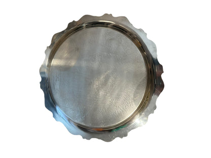 Underside of vintage round silverplate serving tray with scalloped scroll edge