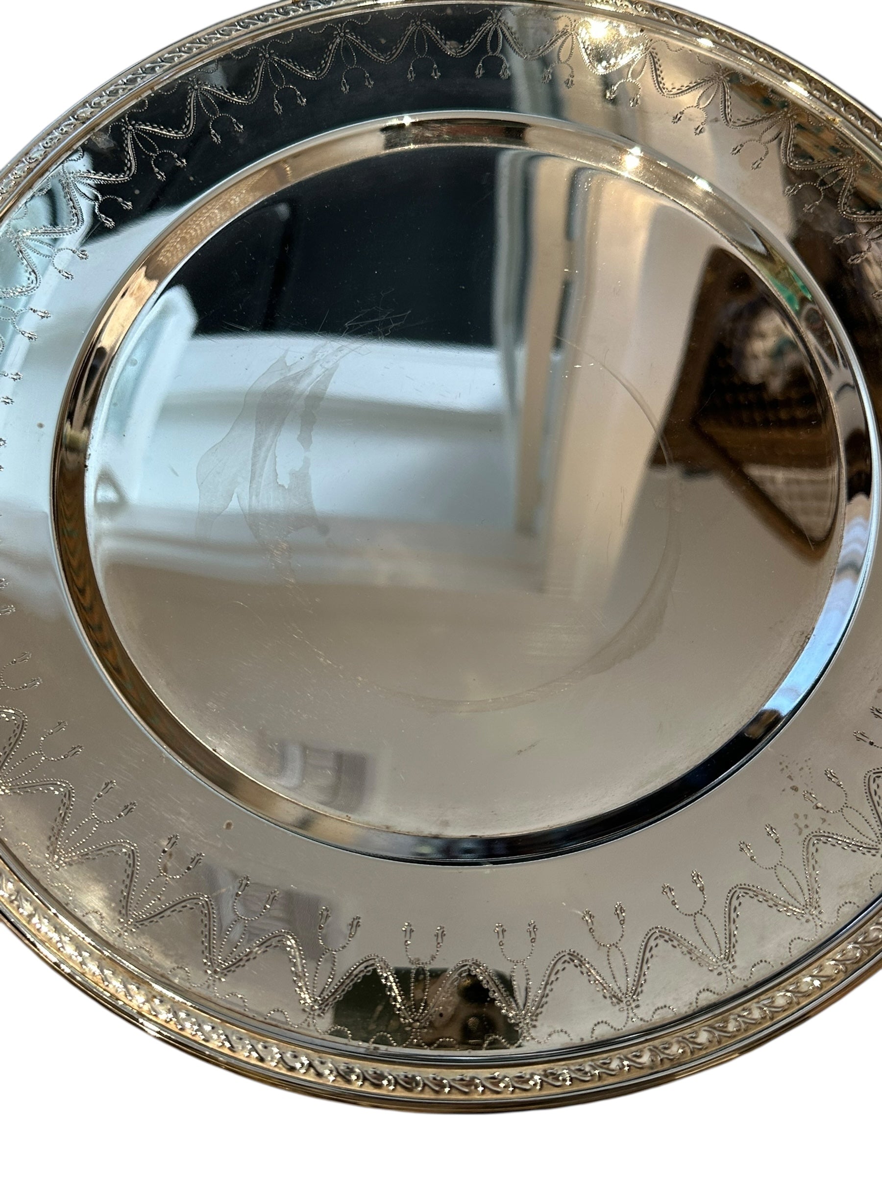 Vintage small round silverplate tray, angled close-up of engraved festoon border and beaded rim