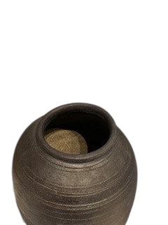 Close-up of the dark ribbed tall vase's mouth and interior opening