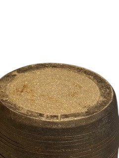 Close-up of the tall vase's unglazed sandy base ring