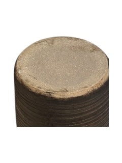 Close-up of the brown ribbed vase's unglazed sandy base, top angle