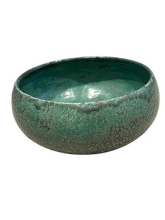 Handmade green glazed stoneware bowl, side profile, mottled green speckled exterior.