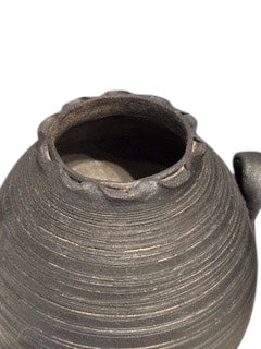 Close-up of the ovoid vase's pinched rim, mouth and lug handle