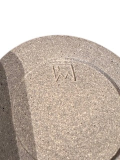 Close-up of vessel's sandy top showing engraved maker's mark.