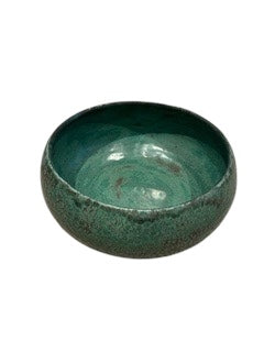 Handmade verdigris green glazed stoneware bowl, angled view of speckled teal interior.