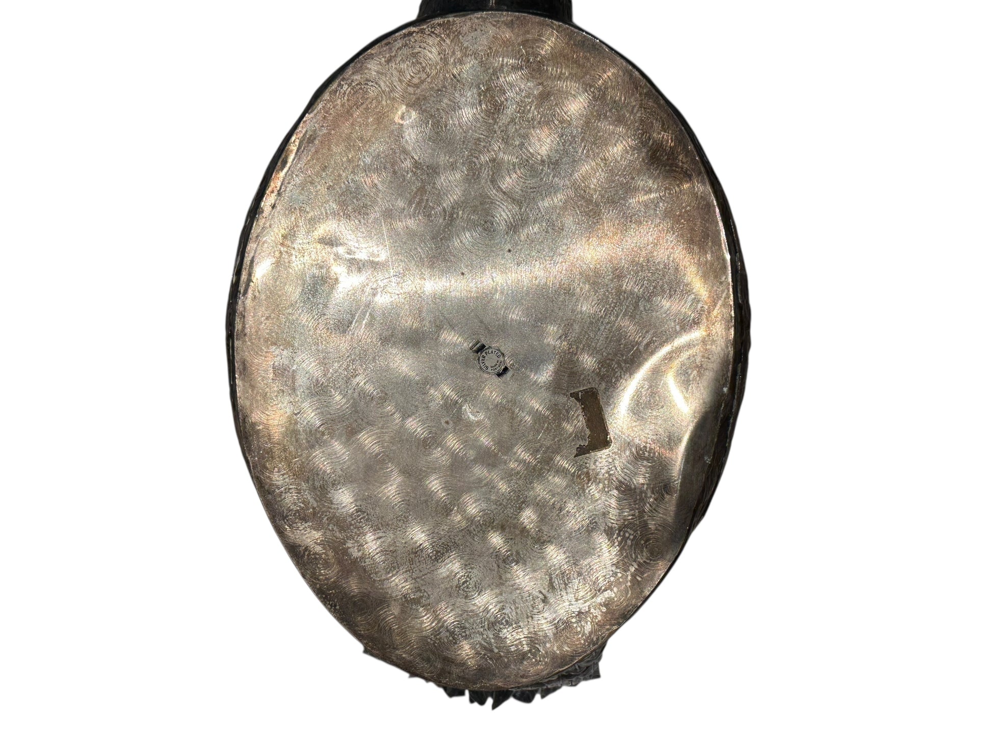 Underside of the silver-plated swan jardiniere showing hammered metal base and maker's stamp