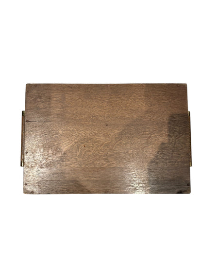 Underside of the medium wooden serving tray showing grain and brass handle mounts