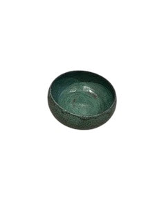 Handmade green glazed stoneware bowl, small footprint, top-down distant view.