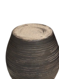 Close-up of the pinched vase's unglazed sandy base