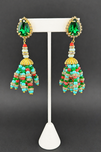 Turquoise, emerald and pink Indian tassel earrings with green crystal tops, on white stand