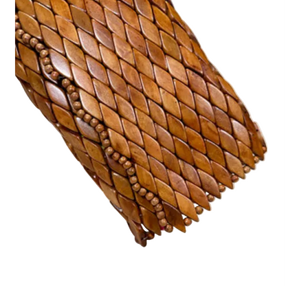 Close-up corner detail of Ma'aM Kind woven wood clutch showing beaded trim edge