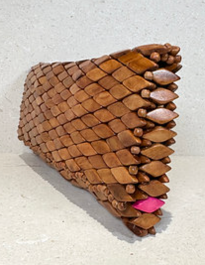 Ma'aM Kind woven wood clutch standing on end, angled view with pink diamond accent