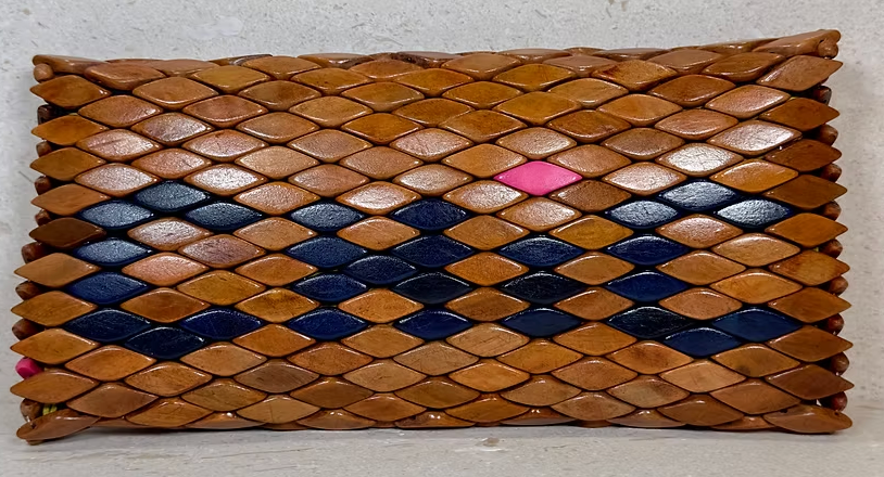 Front view of Ma'aM Kind woven wood clutch, navy diamond band with single pink accent