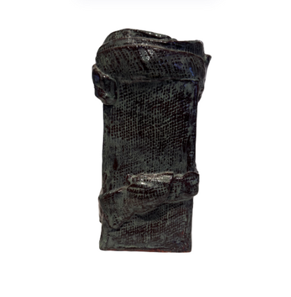 Vintage rectangular ceramic vase with a dark greenish-gray and burgundy glaze, textured crosshatched surface, and raised ceramic bands wrapping around the body. Features an irregular square opening, glossy interior, and unglazed reddish-brown base with an incised maker's mark