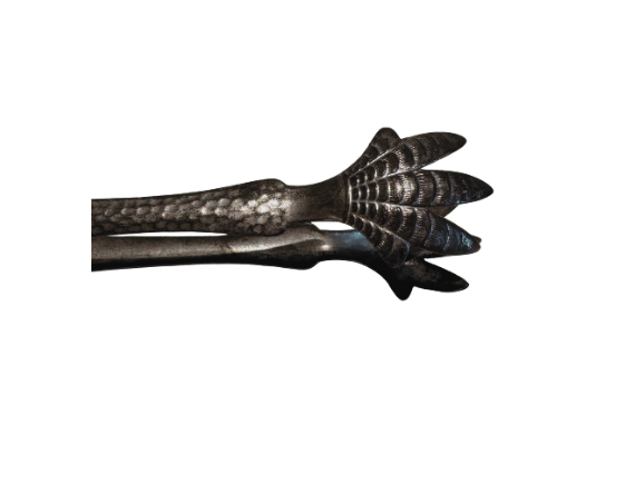 The matching metal ice tongs feature textured arms ending in three-pronged bird claw shapes. The bucket's interior has a hammered texture with visible darkening and discoloration at the bottom.