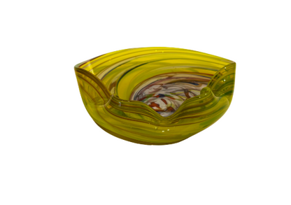 Vintage translucent yellow art glass bowl with a sculptural folded rim and multicolored spiral design featuring white, amber, red, blue, and brown swirls.