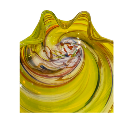 Vintage translucent yellow art glass bowl with a sculptural folded rim and multicolored spiral design featuring white, amber, red, blue, and brown swirls.