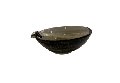 Vintage smoky gray-green glass ashtray with a rounded bowl, evenly spaced controlled bubbles, dark glass rim, and a single clear sculptural cigarette rest.