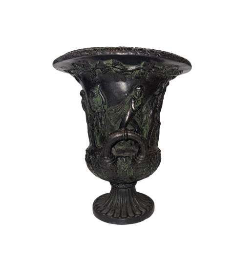 Side View, Black faux-bronze Neoclassical Medici urn with green patina accents, measuring 11 inches tall and 9 inches in diameter. The Campana-shaped vessel features a wide flared rim with egg-and-dart detailing, raised Greco-Roman figures in various poses, grapevine and leaf borders, and two reeded loop handles with bearded mask decorations. An intricate floral and acanthus leaf design surrounds the lower bowl, which rests on a fluted circular pedestal base.