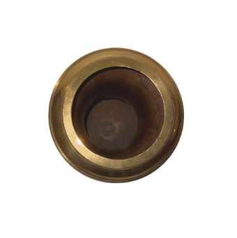 Overhead view of a brass decorative urn showing its circular opening, wide polished rim, and deep hollow interior with darker discoloration and visible signs of age and use.