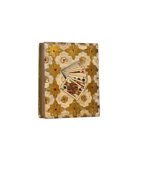  Overhead View: Overhead view of a rectangular Florentine playing card box decorated with repeating gold floral motifs, red accents, and a colorful fan of illustrated playing cards.
