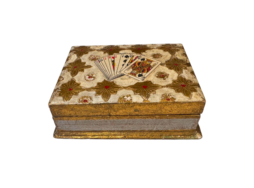 Front View: Vintage Italian Florentine wooden playing card box with a distressed ivory and gold finish, gilded floral motifs, red accents, and an illustration of fanned playing cards on the lid.