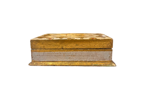 Side Front View: Low-angle view of a rectangular Italian Florentine box with a gilded lid, distressed ivory sides, and a projecting gold-painted base.