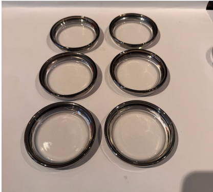  Six vintage clear glass coasters with reflective silver fade rims arranged individually in two columns of three.