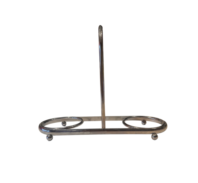 Empty vintage silver-tone metal coaster holder featuring two circular compartments, a central loop handle, and four small ball feet.