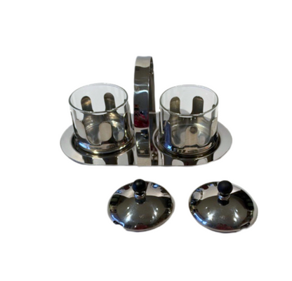 Vintage Michael Graves cream and sugar caddy with removable glass inserts, chrome holders, and black-accented lids.