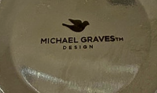 Close-up of the Michael Graves Design maker's mark on the underside of the vintage serving caddy.