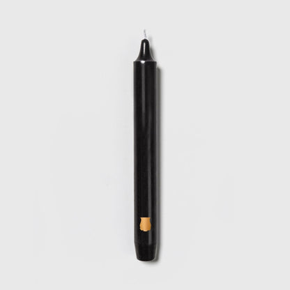 Single Trudon Madeleine black taper candle with gold Trudon crest seal near the base