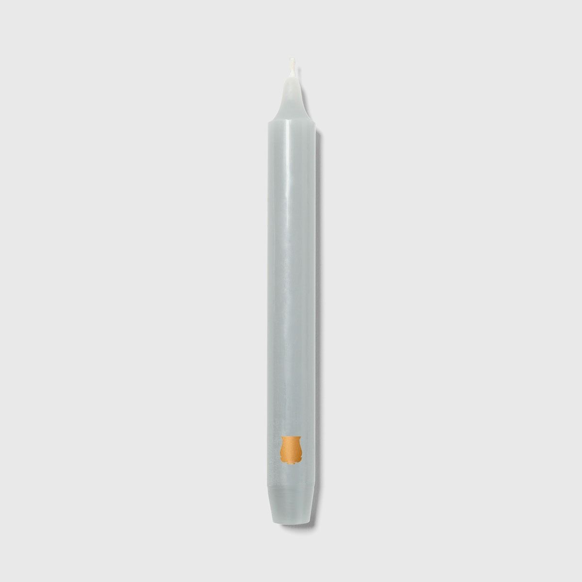 Single Trudon Madeleine grey taper candle with gold Trudon crest seal near the base