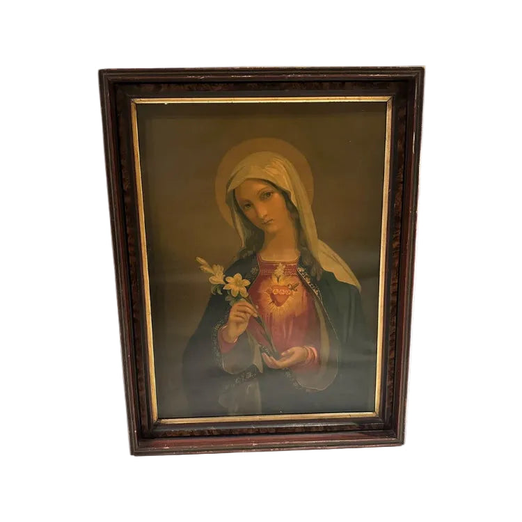 Antique framed oil on canvas of the Immaculate Heart of Mary holding a lily, in a dark wood frame, front view