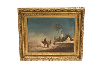 Antique framed oil on canvas Orientalist scene of robed figures and camels near a desert mosque with palm trees, in an ornate gilt frame