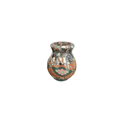 Jean Gerbino mosaic vase, front view, with a pink flower and green, terracotta and blue tilework