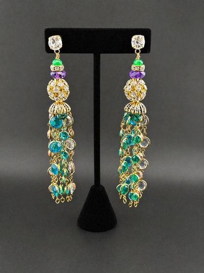 Chandelier gemstone tassel earrings with crystal ball and teal beaded fringe, on black stand
