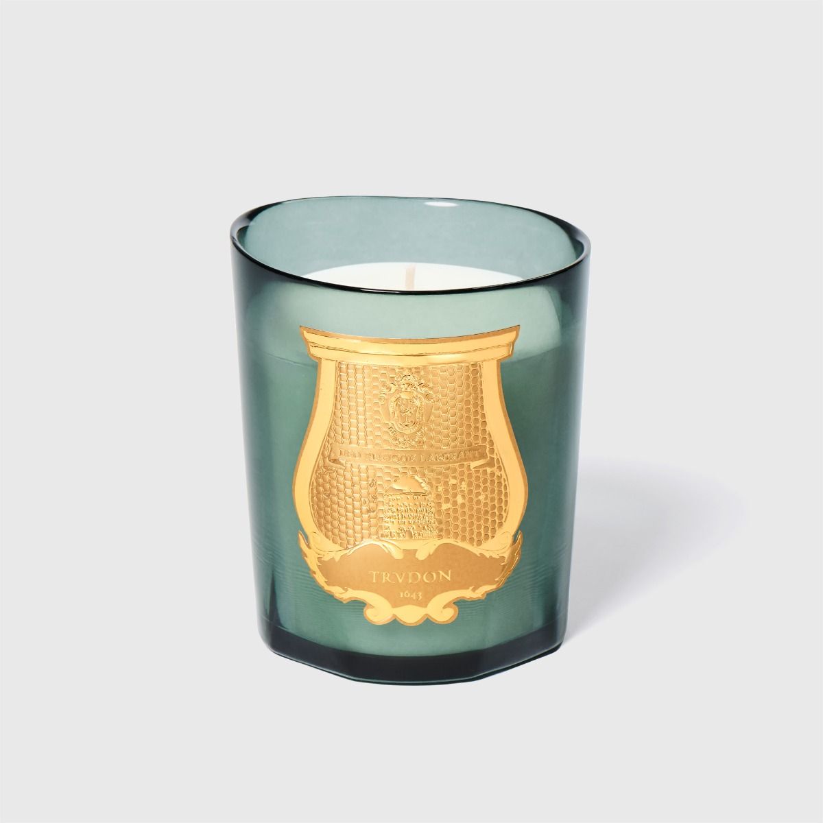 Trudon Figuerie candle in green glass vessel with gold embossed Trudon crest