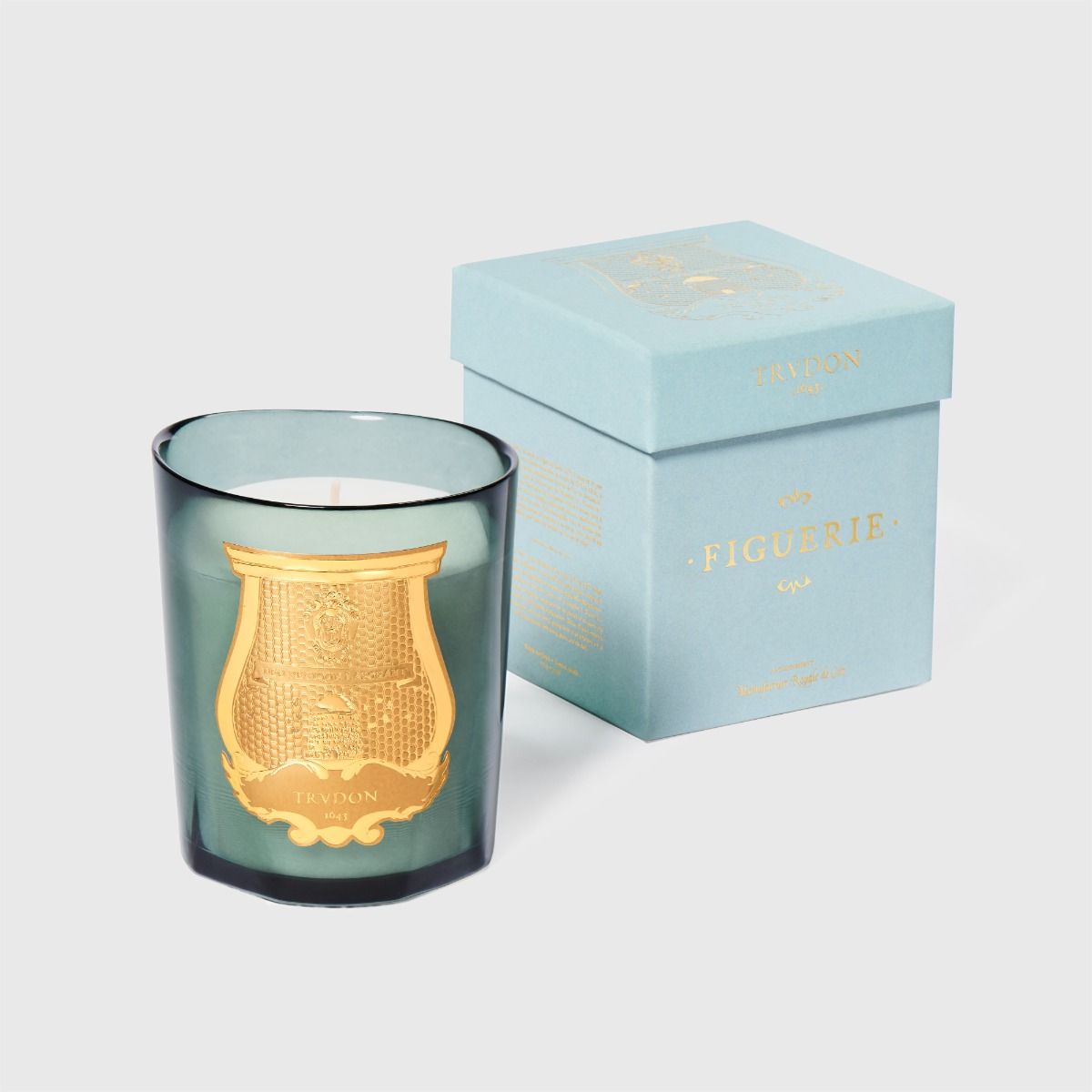 Trudon Figuerie candle beside its pale blue gold-embossed gift box