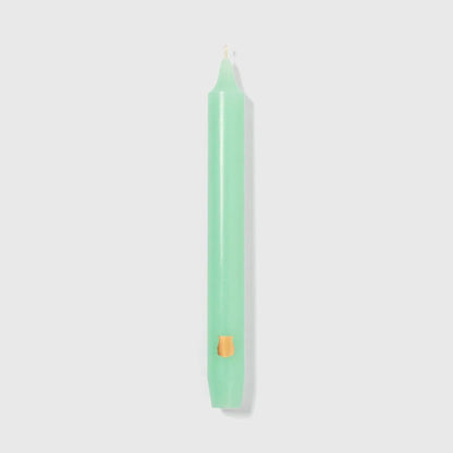 Pale green Vert d'Eau Trudon Madeleine taper candle upright with a gold crest